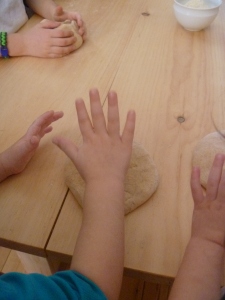 Little hands patting the dough.