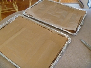 Baking sheets lined with aluminum foil and brown paper.