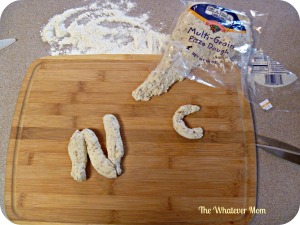 Pick up premade bread dough or pizza dough to create letter shapes