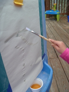Use paint brush to apply tea to paper