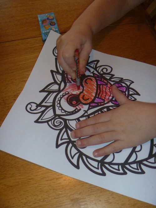 Coloring our dragon masks. 